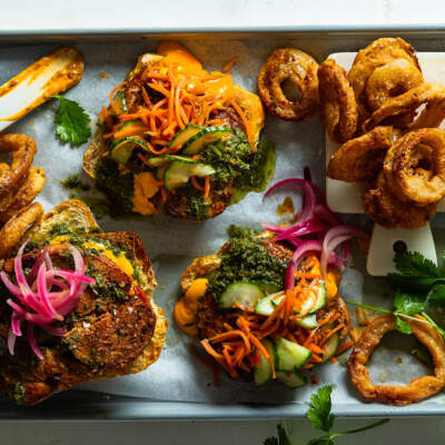 Pork steak burgers with chimichurri and battered onion rings