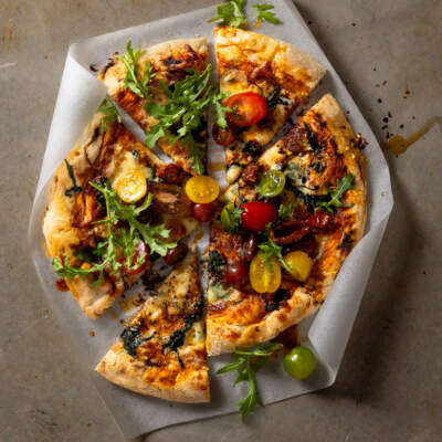 Spicy calabrian chilli & spinach pizza with exotic tomato salad